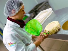 Mathilde confectionne un vacherin meringué dans son atelier de la Ferme Saint-Yves